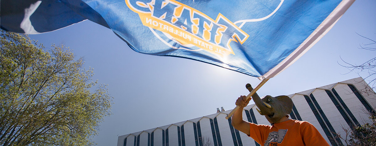 CSUF student waving a Titans flag