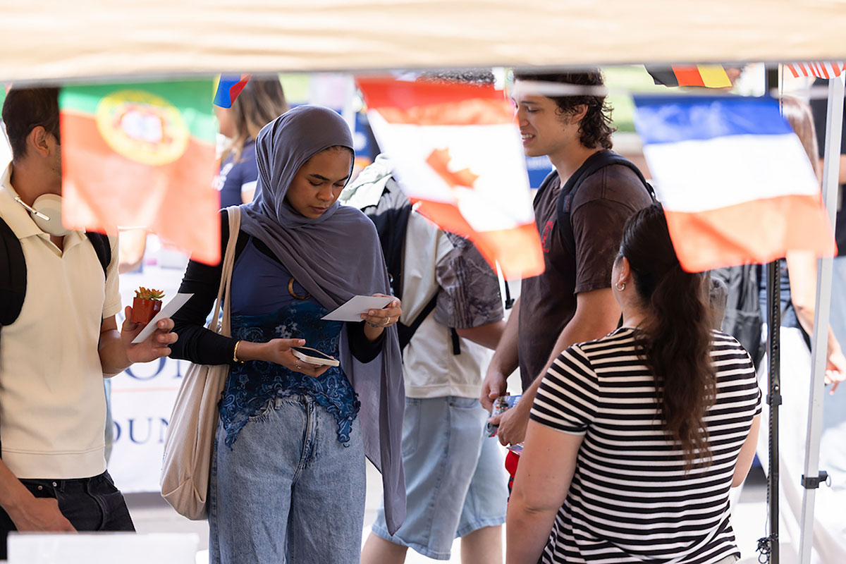 International students on campus International students walking on campus and viewing information on their phones.